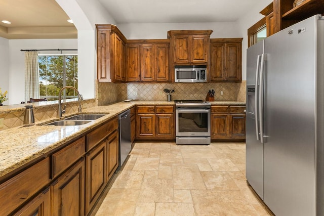 2804 Lohmans Ford Rd Unit B, Lago Vista, TX 78645 - kitchen with appliances with stainless steel finishes, light stone countertops, backsplash, recessed lighting, and arched walkways