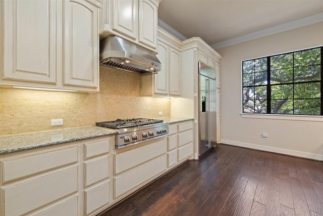 1036 Liberty Park Dr Unit 401/4A, Austin, TX 78746 - kitchen with under cabinet range hood, appliances with stainless steel finishes, dark wood-style floors, backsplash, and crown molding