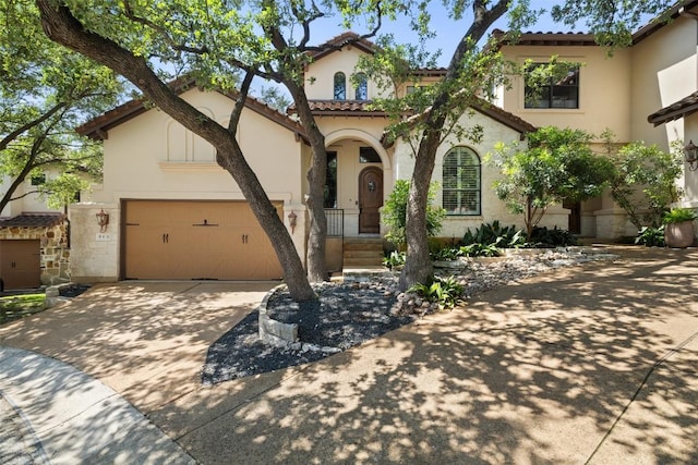 1036 Liberty Park Dr Unit 401/4A, Austin, TX 78746 - mediterranean / spanish-style house with stucco siding, concrete driveway, a garage, and a tiled roof