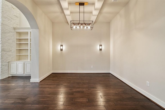 1036 Liberty Park Dr Unit 401/4A, Austin, TX 78746 - unfurnished room featuring dark wood-style floors, arched walkways, baseboards, and built in shelves