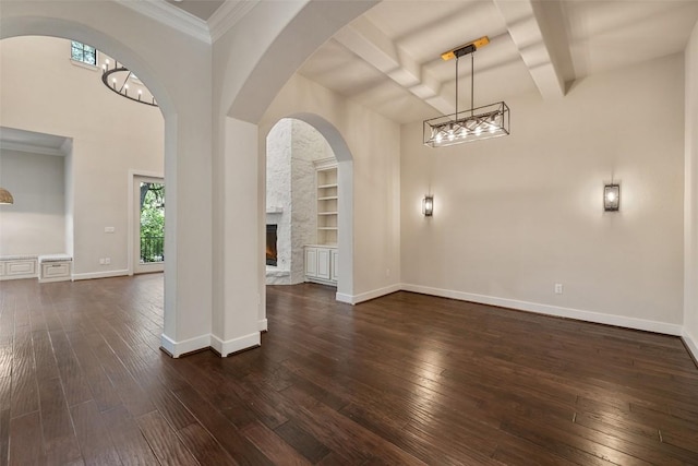 1036 Liberty Park Dr Unit 401/4A, Austin, TX 78746 - foyer with dark wood-type flooring, a fireplace, baseboards, a chandelier, and a towering ceiling