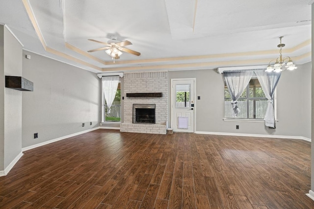 1008 Woodshadows Dr, Harker Heights, TX 76548 - unfurnished living room featuring a tray ceiling, ceiling fan, a fireplace, wood finished floors, and baseboards