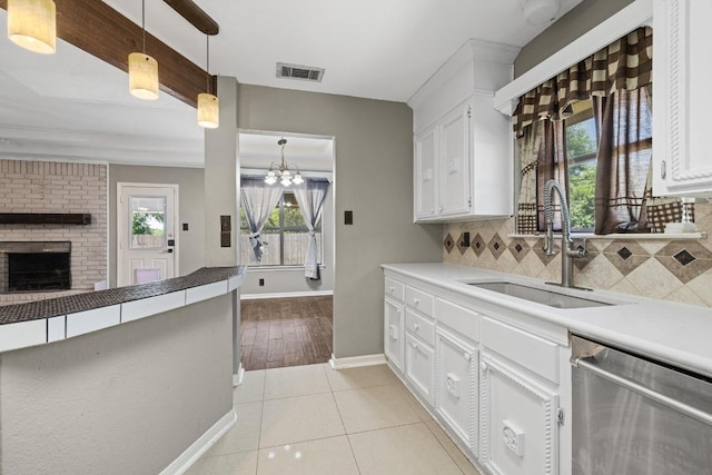 1008 Woodshadows Dr, Harker Heights, TX 76548 - kitchen featuring a sink, dishwasher, backsplash, white cabinetry, and baseboards