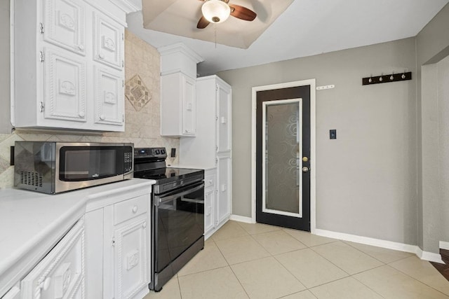 1008 Woodshadows Dr, Harker Heights, TX 76548 - kitchen with black range with electric stovetop, stainless steel microwave, light countertops, decorative backsplash, and a ceiling fan