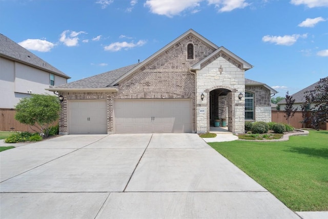 4937 Strada Dr, Round Rock, TX 78665 - french country style house with driveway, an attached garage, and stone siding