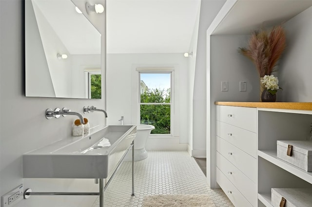 1112 W 10th St, Austin, TX 78703 - bathroom featuring vanity, a soaking tub, and baseboards