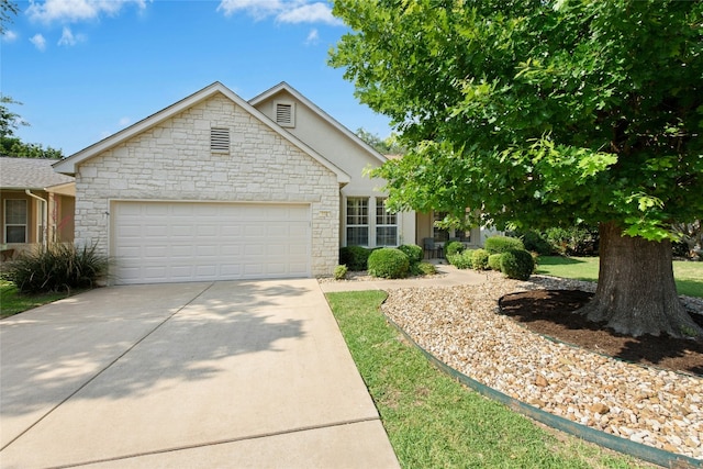 112 Anemone Way, Georgetown, TX 78633 - view of front facade featuring stone siding, an attached garage, concrete driveway, and stucco siding