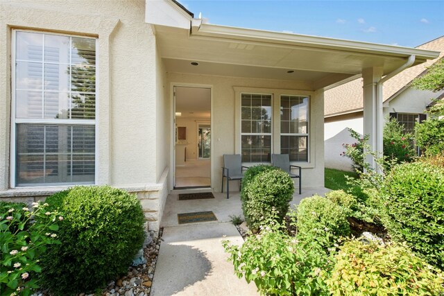 112 Anemone Way, Georgetown, TX 78633 - doorway to property featuring stucco siding and a porch