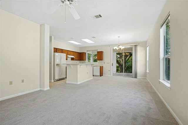 112 Anemone Way, Georgetown, TX 78633 - unfurnished living room with a chandelier, light carpet, baseboards, and a ceiling fan