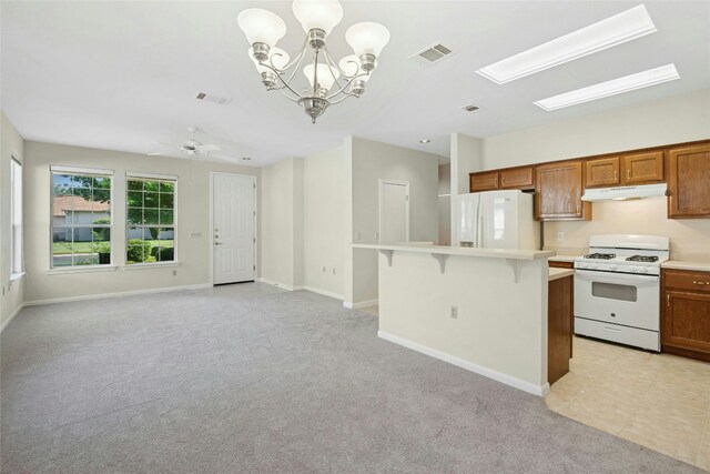 112 Anemone Way, Georgetown, TX 78633 - kitchen featuring white appliances, under cabinet range hood, a kitchen bar, light carpet, and light countertops