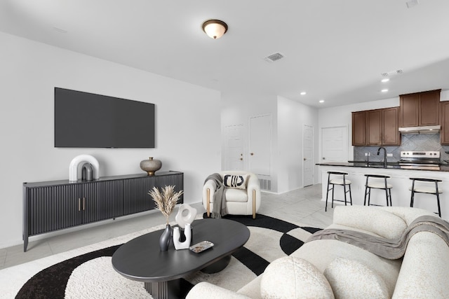 14516 Isidors Eagle Way, Elgin, TX 78621 - living room featuring recessed lighting and light marble finish flooring