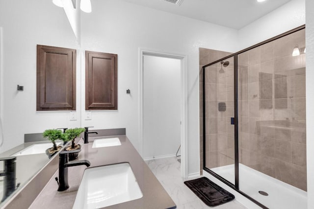 14516 Isidors Eagle Way, Elgin, TX 78621 - bathroom with double vanity, a shower stall, marble finish floors, and toilet