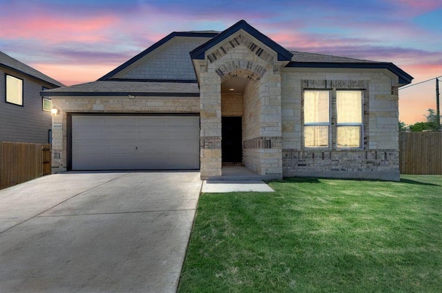 14516 Isidors Eagle Way, Elgin, TX 78621 - french country style house featuring stone siding, concrete driveway, and a garage