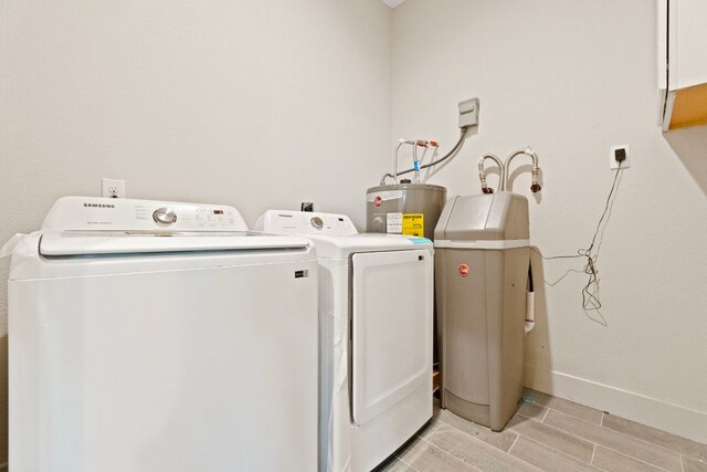757 Canyon Bnd, Canyon Lake, TX 78133 - washroom featuring washing machine and dryer, water heater, and wood finish floors