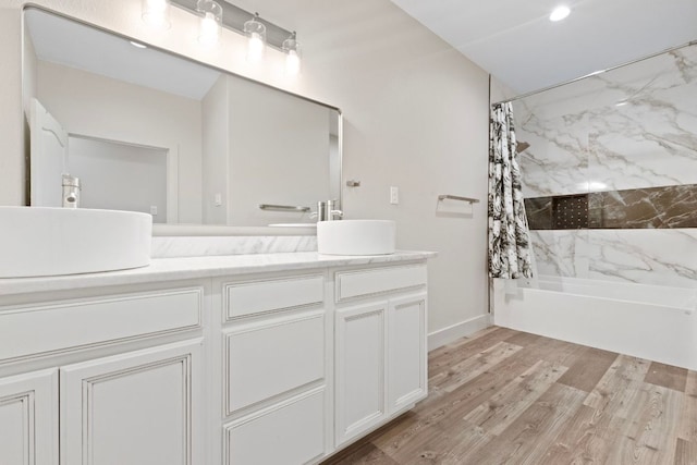 757 Canyon Bnd, Canyon Lake, TX 78133 - full bath with double vanity, shower / bath combo with shower curtain, and wood finished floors