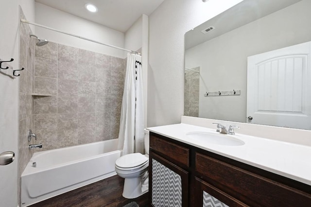 328 Triumph Rd, Buda, TX 78610 - full bathroom featuring shower / bath combo with shower curtain, toilet, vanity, and wood finished floors