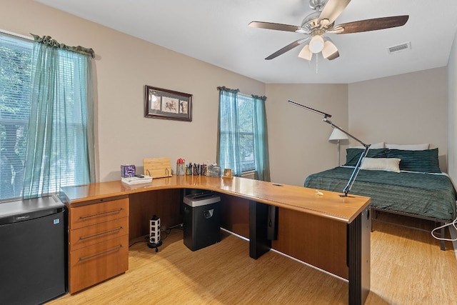 11713 Rydalwater Ln, Austin, TX 78754 - home office with light wood-style flooring and a ceiling fan