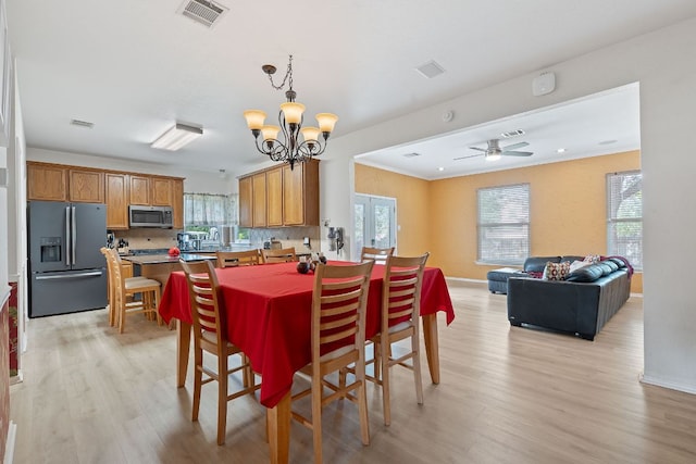 11713 Rydalwater Ln, Austin, TX 78754 - dining room with light wood finished floors, a chandelier, and healthy amount of natural light