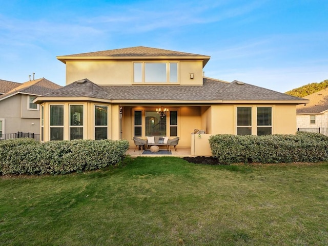 307 Ansley Cv, Lakeway, TX 78738 - back of property featuring roof with shingles, stucco siding, a patio area, and an outdoor living space