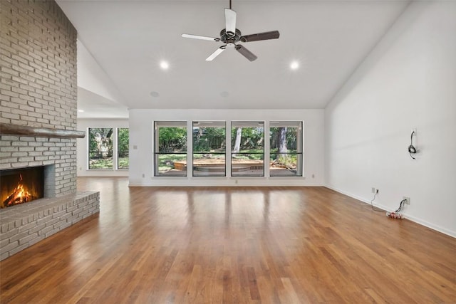1302 Wilderness Dr, Austin, TX 78746 - unfurnished living room featuring high vaulted ceiling, healthy amount of natural light, a brick fireplace, baseboards, and recessed lighting