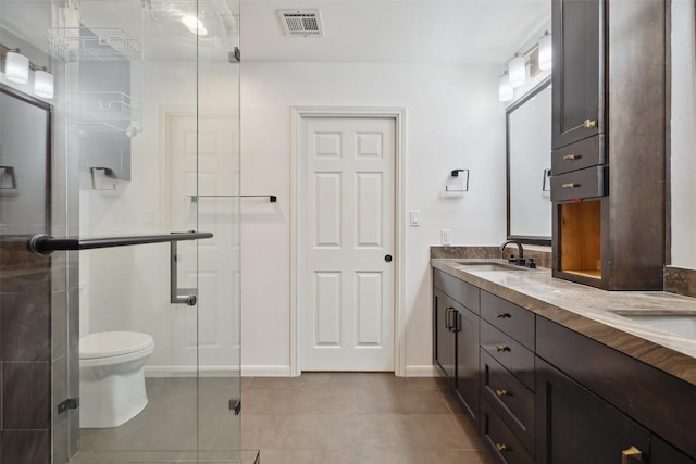 1302 Wilderness Dr, Austin, TX 78746 - full bathroom with double vanity, a shower stall, toilet, tile patterned floors, and baseboards