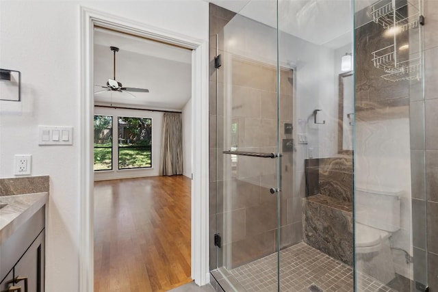 1302 Wilderness Dr, Austin, TX 78746 - bathroom with a ceiling fan, vanity, a stall shower, and wood finished floors