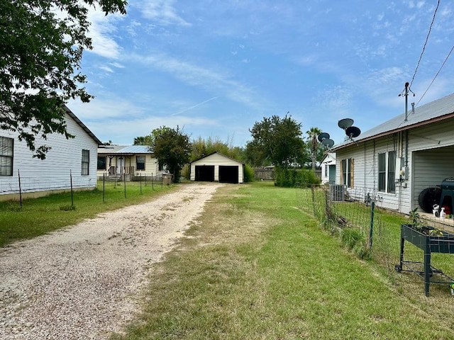 411 N Swenson St Unit 411, Falls City, TX 78113 - view of yard featuring a garage, an outdoor structure, and cooling unit