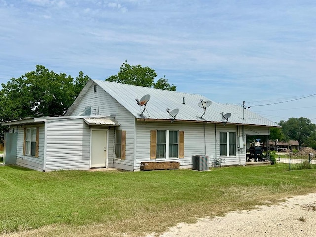411 N Swenson St Unit 411, Falls City, TX 78113 - rear view of house with a lawn and metal roof