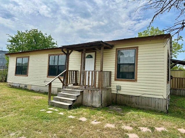 411 N Swenson St Unit 411, Falls City, TX 78113 - manufactured / mobile home featuring a front lawn