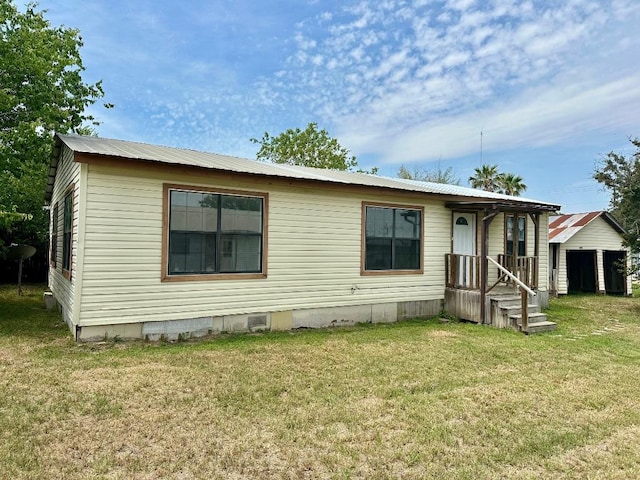 411 N Swenson St Unit 411, Falls City, TX 78113 - manufactured / mobile home with metal roof, a front lawn, and crawl space