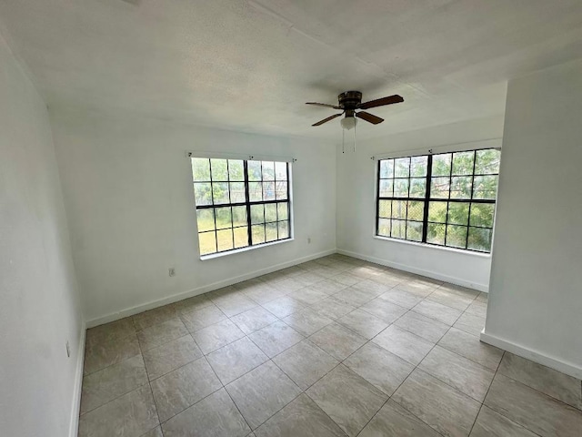 411 N Swenson St Unit 411, Falls City, TX 78113 - spare room featuring ceiling fan, baseboards, and tile patterned floors