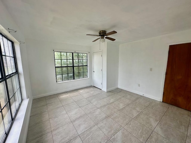 411 N Swenson St Unit 411, Falls City, TX 78113 - empty room featuring light tile patterned floors, ceiling fan, and baseboards