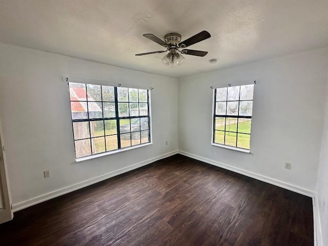 411 N Swenson St Unit 411, Falls City, TX 78113 - unfurnished room featuring dark wood-style flooring, a ceiling fan, baseboards, and a smoke detector