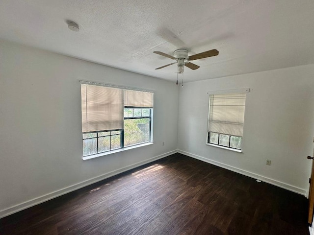 411 N Swenson St Unit 411, Falls City, TX 78113 - spare room featuring dark wood finished floors, ceiling fan, baseboards, a textured ceiling, and a smoke detector