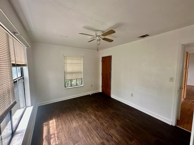 411 N Swenson St Unit 411, Falls City, TX 78113 - unfurnished room featuring dark wood-style flooring, a ceiling fan, and baseboards