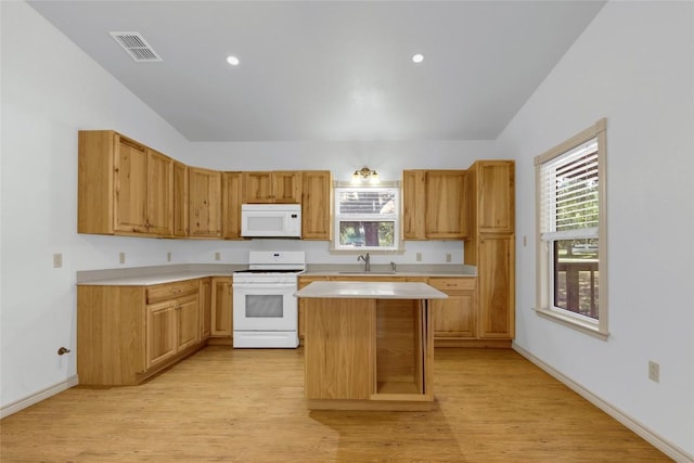 242 Meadow Lake Dr, Seguin, TX 78155 - kitchen featuring white appliances, a sink, light countertops, light wood finished floors, and lofted ceiling