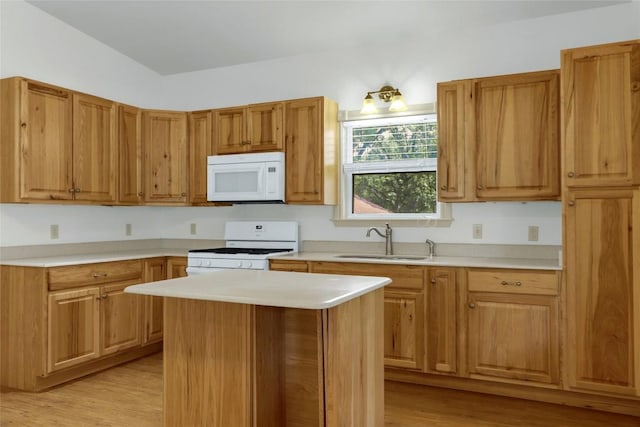 242 Meadow Lake Dr, Seguin, TX 78155 - kitchen featuring white appliances, a sink, light countertops, and light wood-style flooring