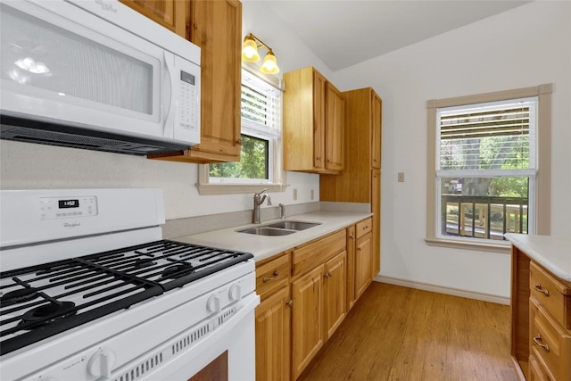 242 Meadow Lake Dr, Seguin, TX 78155 - kitchen featuring white appliances, a sink, light wood-style floors, and light countertops