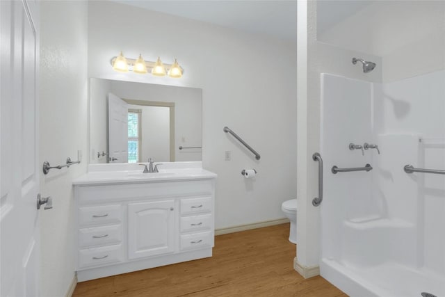 242 Meadow Lake Dr, Seguin, TX 78155 - full bath with a shower, vanity, wood finished floors, toilet, and baseboards
