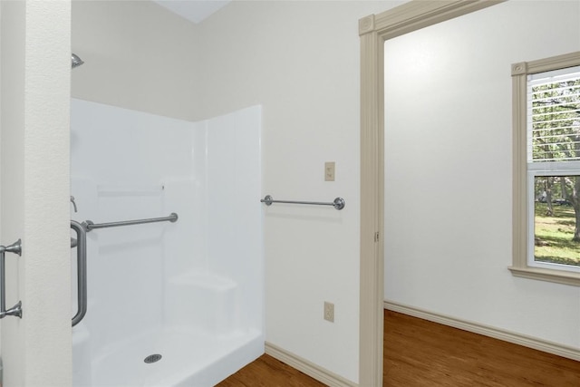 242 Meadow Lake Dr, Seguin, TX 78155 - bathroom featuring a shower, wood finished floors, and baseboards