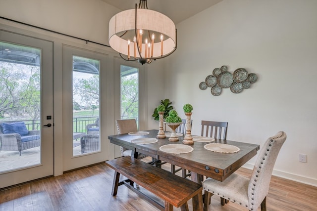 302 Parallel Cir, Horseshoe Bay, TX 78657 - dining space with wood finished floors, a chandelier, baseboards, and french doors