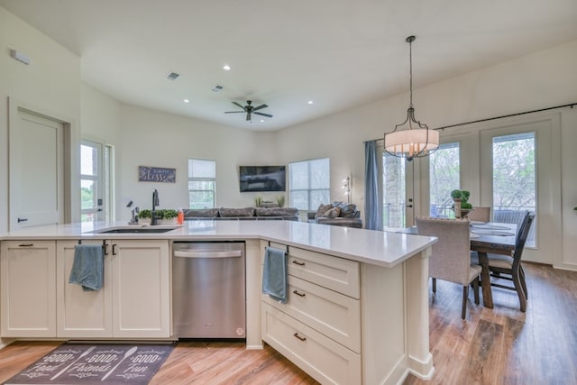 302 Parallel Cir, Horseshoe Bay, TX 78657 - kitchen with stainless steel dishwasher, a sink, light wood finished floors, light countertops, and a chandelier