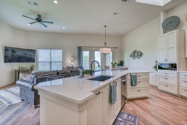 302 Parallel Cir, Horseshoe Bay, TX 78657 - kitchen featuring a sink, light wood finished floors, open floor plan, stainless steel dishwasher, and a center island with sink