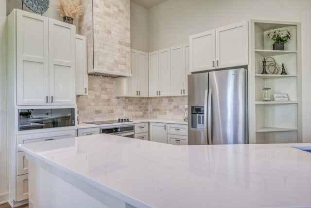 302 Parallel Cir, Horseshoe Bay, TX 78657 - kitchen with stainless steel appliances, open shelves, backsplash, light stone countertops, and wall chimney range hood