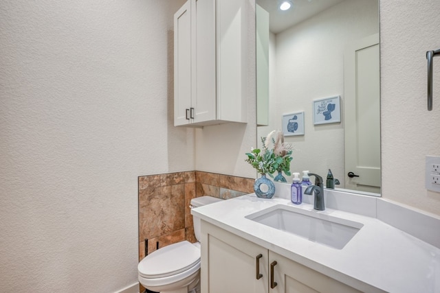 302 Parallel Cir, Horseshoe Bay, TX 78657 - half bath with toilet, vanity, tile walls, a textured wall, and recessed lighting