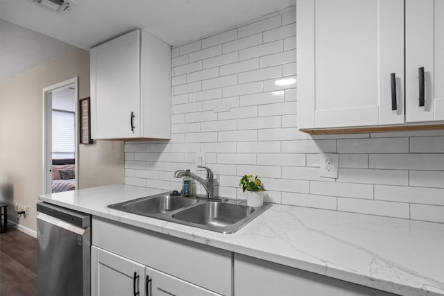 1800 Lavaca St Unit 307, Austin, TX 78701 - kitchen with dishwasher, white cabinetry, decorative backsplash, and dark wood finished floors