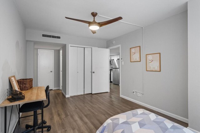 1800 Lavaca St Unit 307, Austin, TX 78701 - bedroom featuring freestanding refrigerator, wood finished floors, a closet, and an office area