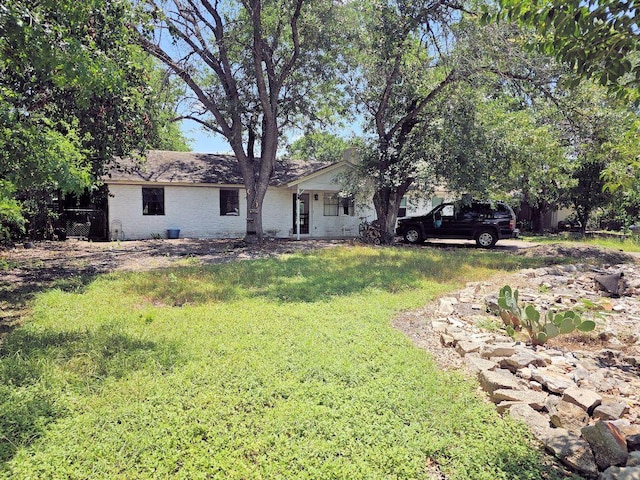 105 Park Dr S, Kyle, TX 78640 - view of front facade with brick siding and a front lawn