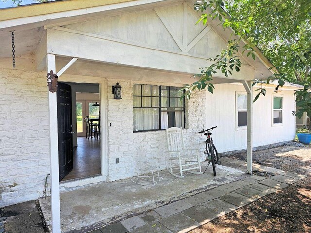 105 Park Dr S, Kyle, TX 78640 - property entrance with covered porch and stone siding