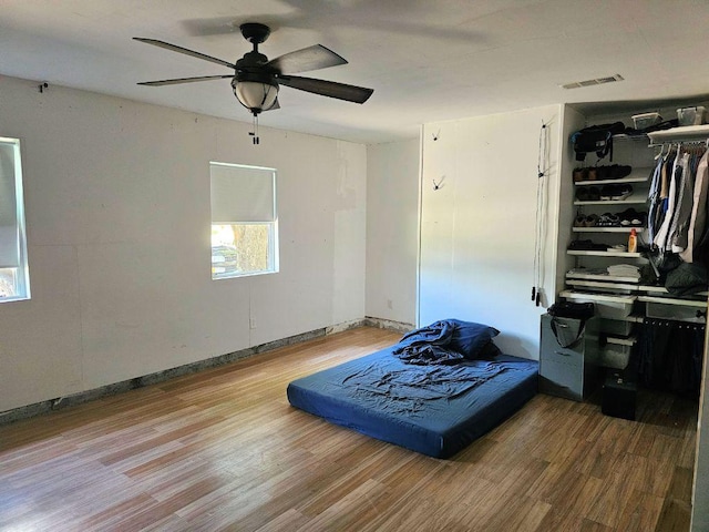 105 Park Dr S, Kyle, TX 78640 - bedroom featuring wood finished floors, a closet, and ceiling fan